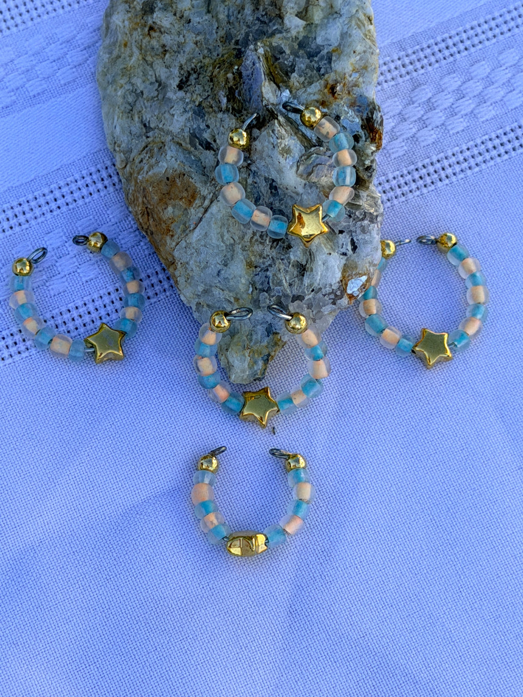 Gold Star Ring group shot on rock blue background