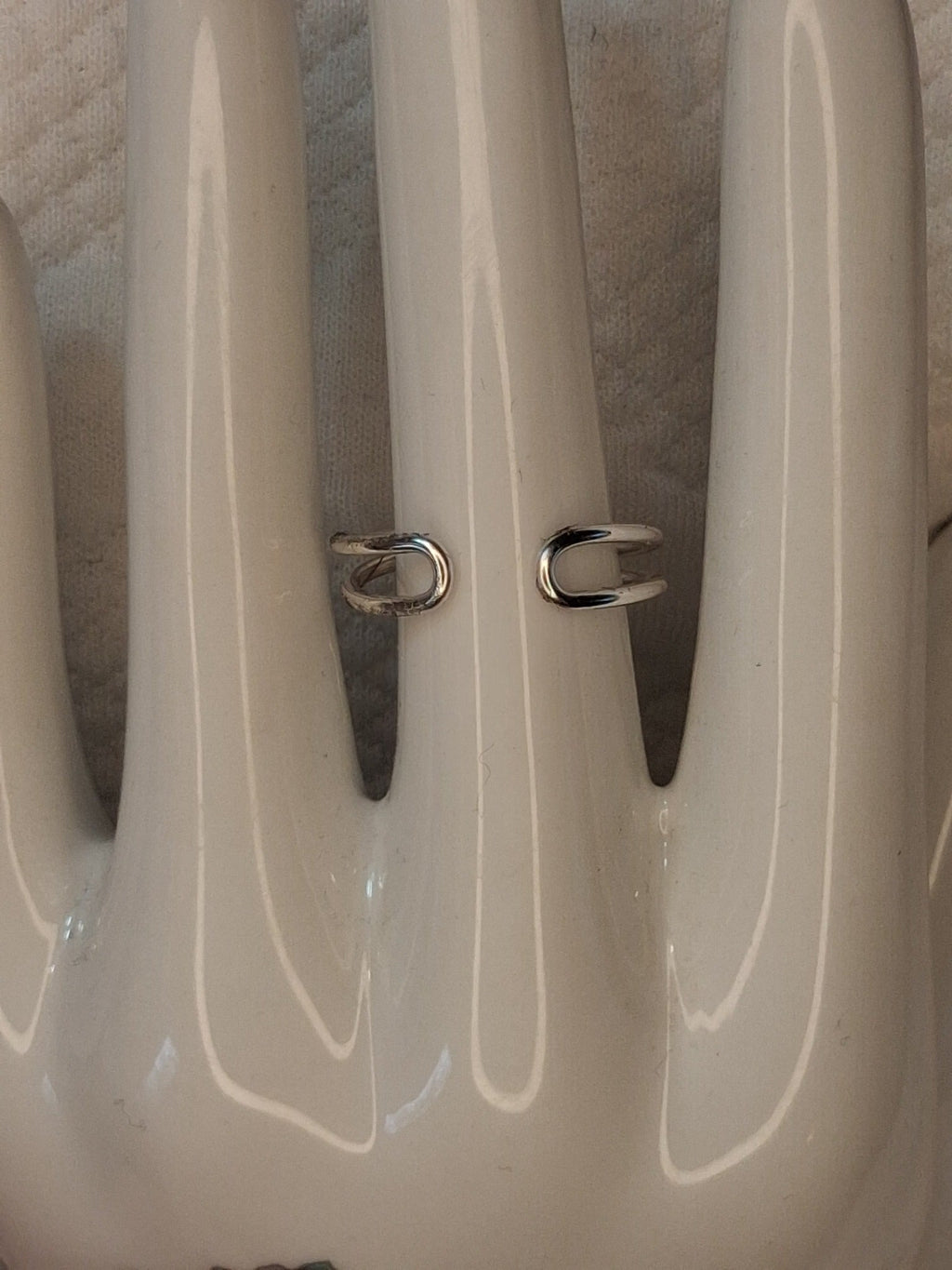 Example back view showing the open adjustable band and rounded wire ends of a silver wire ring.
