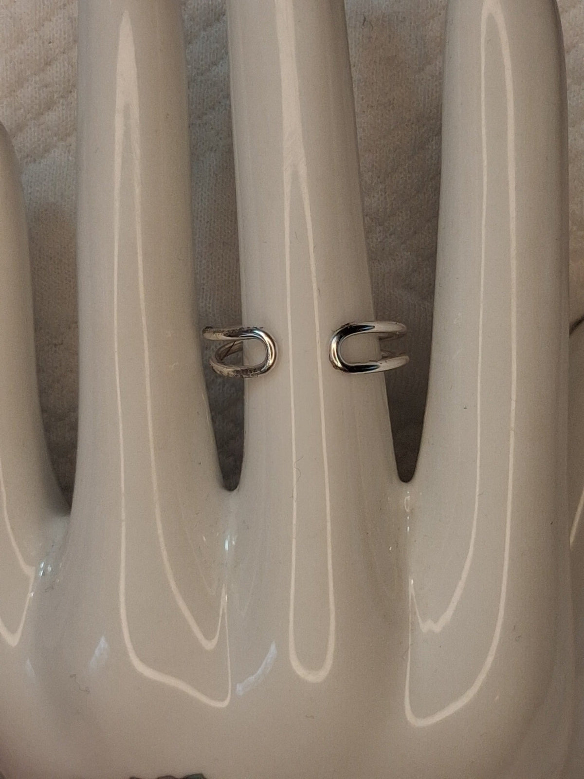 Example back view showing the open adjustable band and rounded wire ends of a silver wire ring.